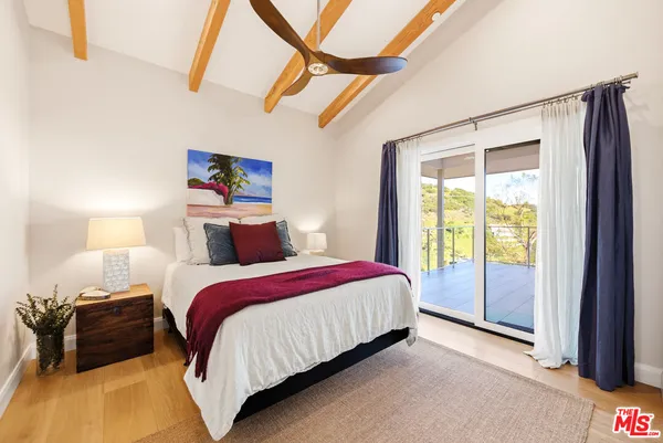 a spacious bedroom with a bed and a window