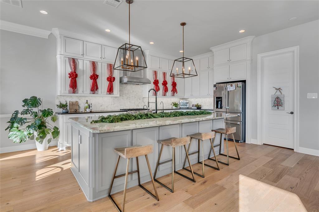 13753 Green Elm Road Fort Worth, TX 76008 - Photo 12 of 38 a kitchen with stainless steel appliances granite countertop a kitchen island a stove and a refrigerator