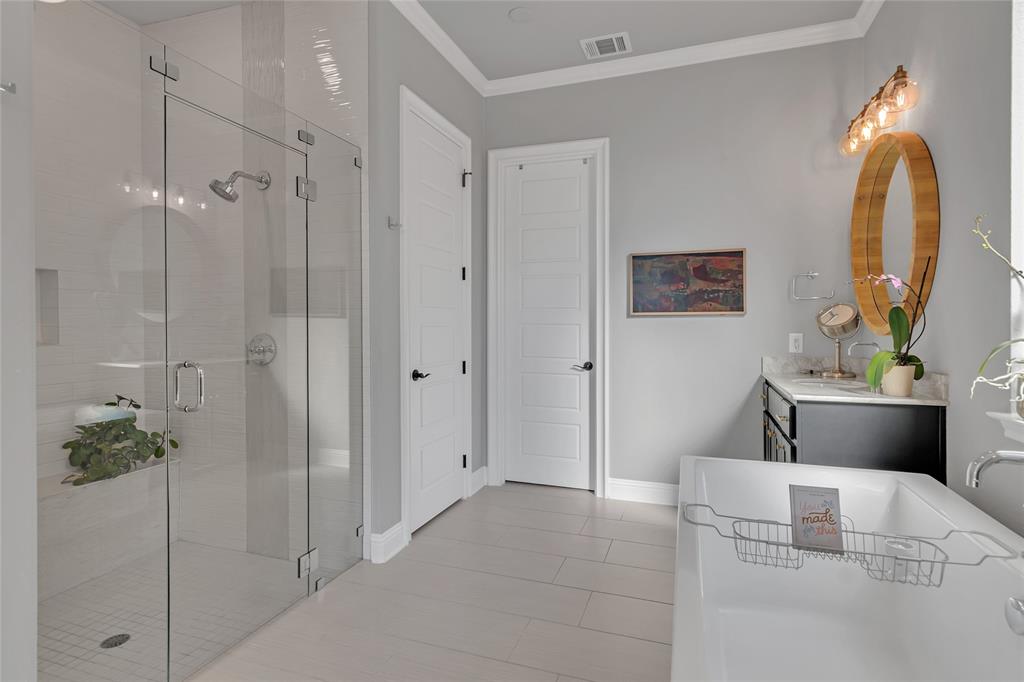 13753 Green Elm Road Fort Worth, TX 76008 - Photo 19 of 38 a spacious bathroom with a granite countertop sink a mirror a vanity and shower