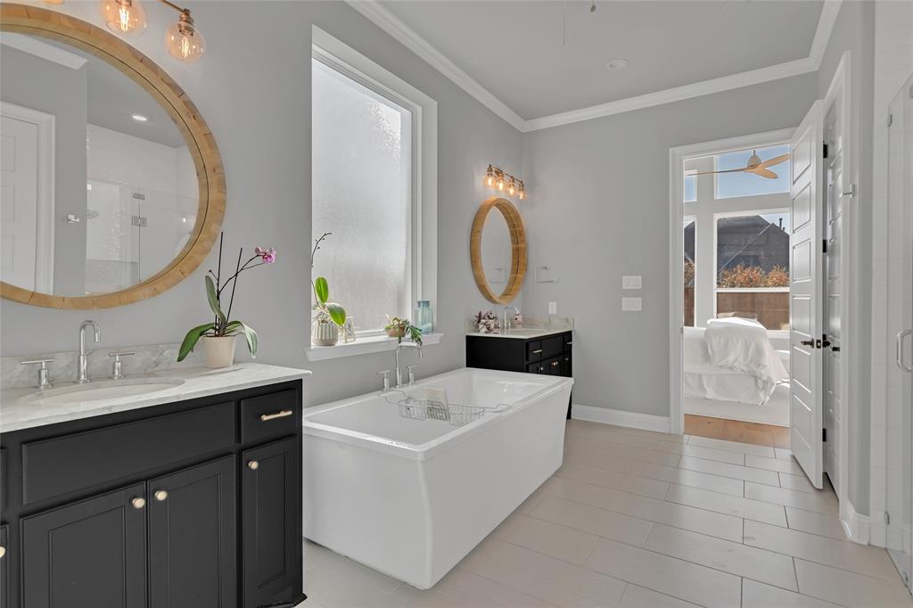 13753 Green Elm Road Fort Worth, TX 76008 - Photo 20 of 38 a spacious bathroom with a tub sink and mirror