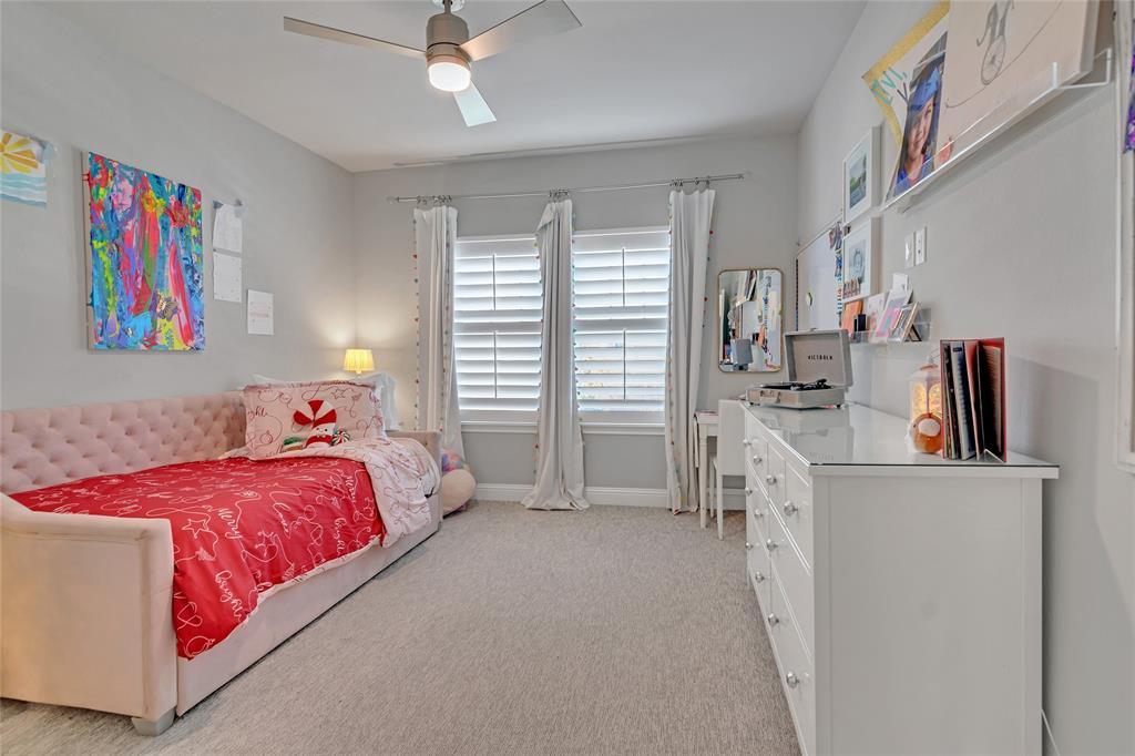 13753 Green Elm Road Fort Worth, TX 76008 - Photo 30 of 38 a bed room with a bed and a book shelf