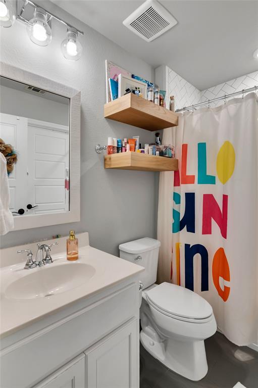 13753 Green Elm Road Fort Worth, TX 76008 - Photo 31 of 38 a bathroom with a sink a toilet and a shower