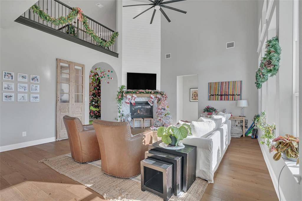 13753 Green Elm Road Fort Worth, TX 76008 - Photo 8 of 38 a living room with furniture a flat screen tv and a fireplace