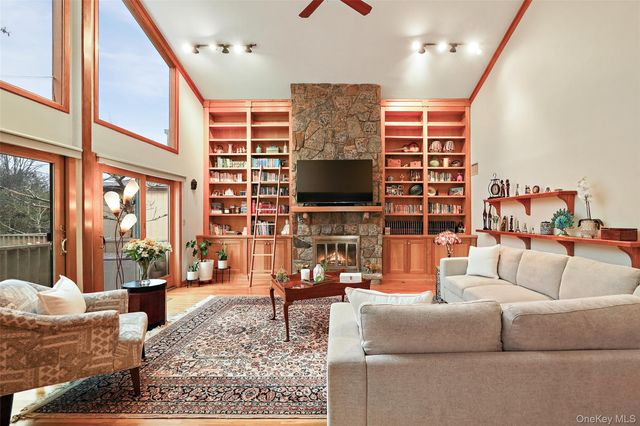 a living room with fireplace furniture and a flat screen tv