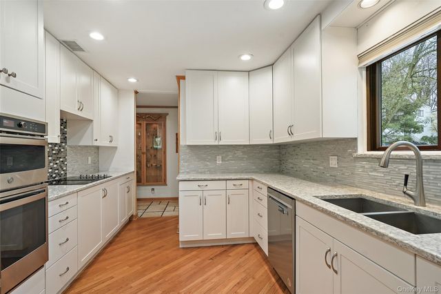 a kitchen with a sink stove and cabinets