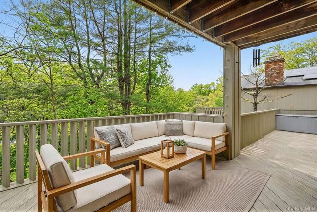 a balcony with table and chairs