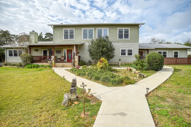 a view of a house with swimming pool and furniture