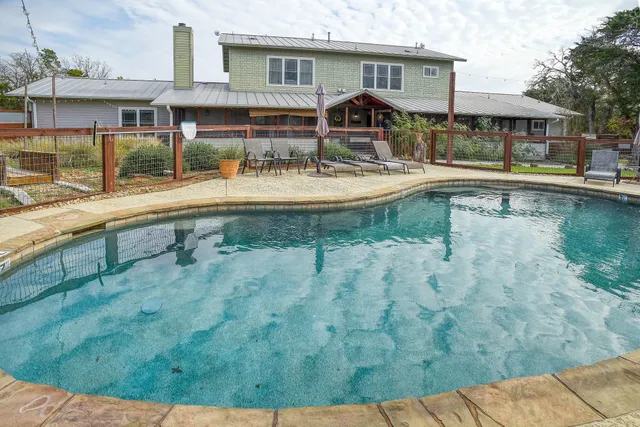 a swimming pool view with a outdoor seating