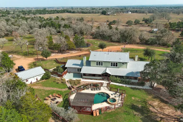 an aerial view of a house with a lake view