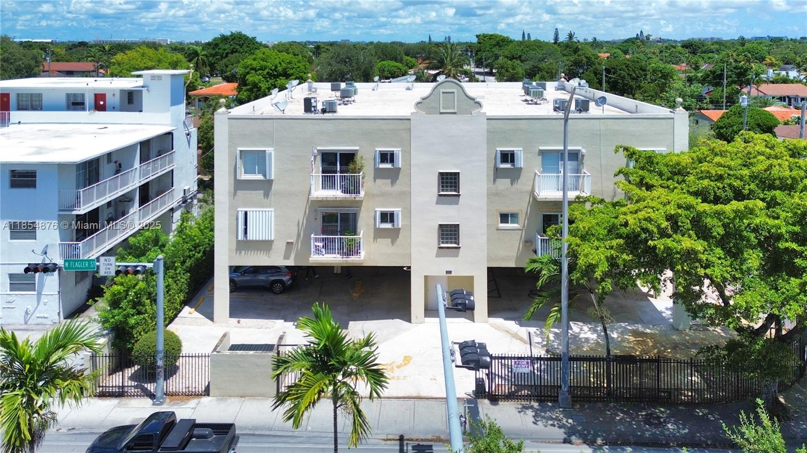 an aerial view of a house with a yard and potted plants