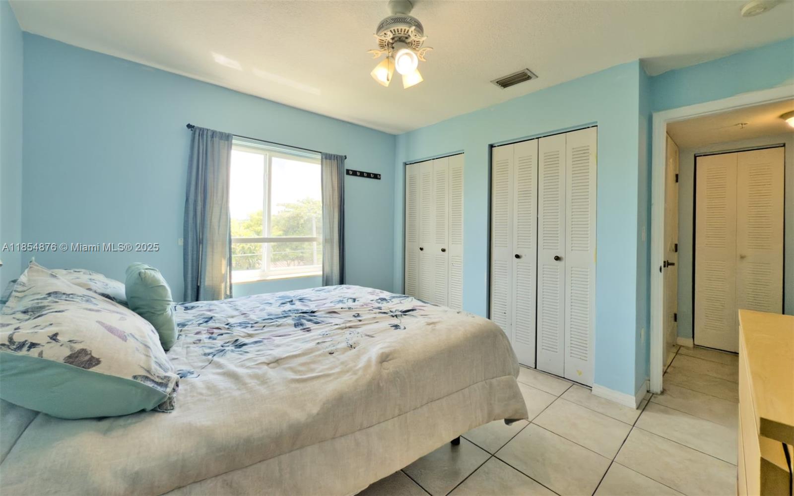 3201 West Flagler Street, Unit 209 Miami, FL 33135 - Photo 11 of 13 a bedroom with a bed and a window