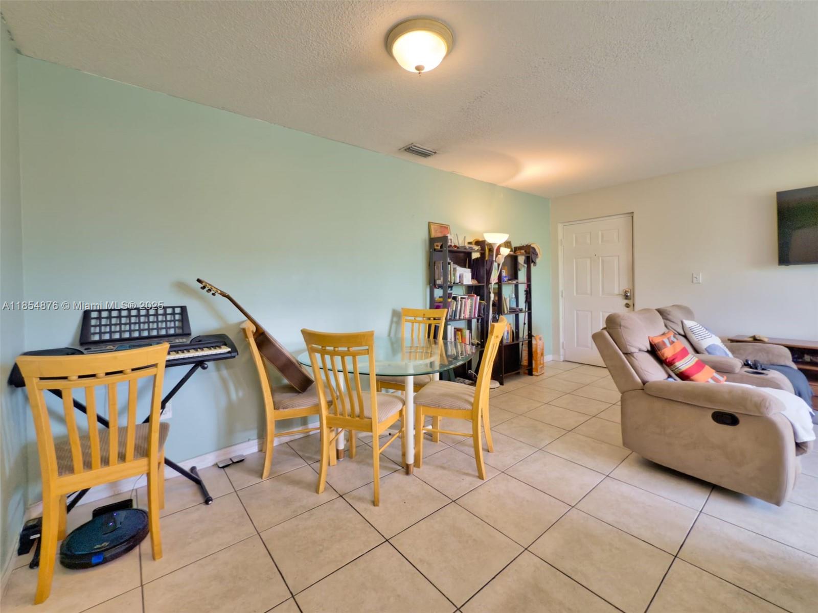 3201 West Flagler Street, Unit 209 Miami, FL 33135 - Photo 4 of 13 a living room with furniture and a gym machine