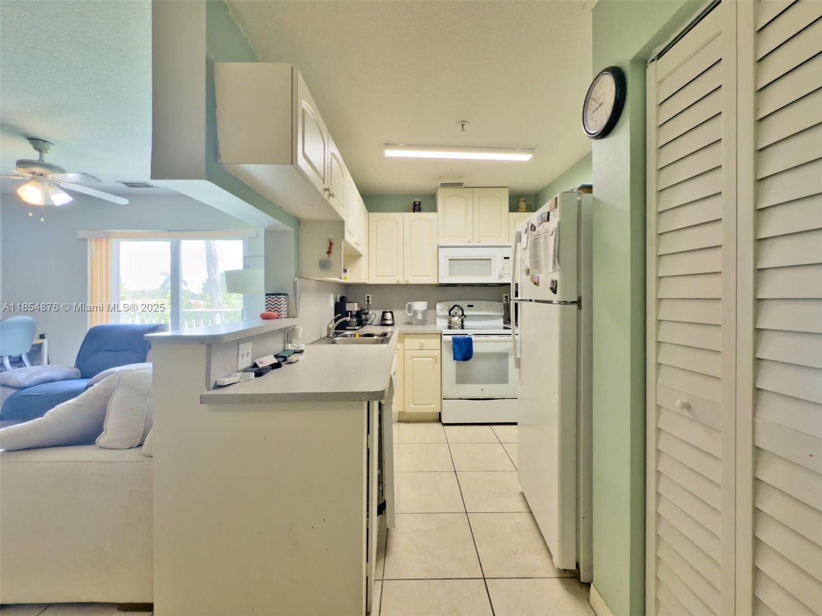 3201 West Flagler Street, Unit 209 Miami, FL 33135 - Photo 7 of 13 a kitchen with stainless steel appliances a refrigerator and a stove top oven