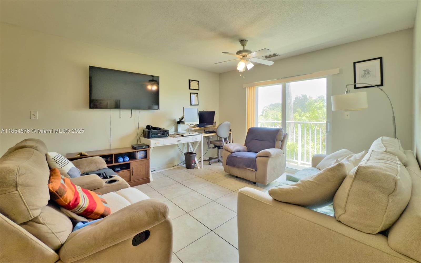 3201 West Flagler Street, Unit 209 Miami, FL 33135 - Photo 8 of 13 a living room with furniture and a flat screen tv
