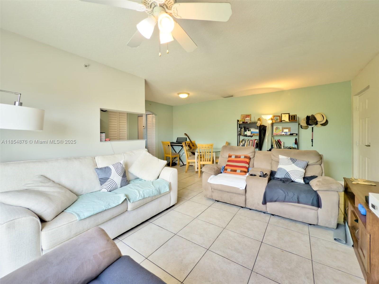 3201 West Flagler Street, Unit 209 Miami, FL 33135 - Photo 9 of 13 a living room with furniture and a chandelier