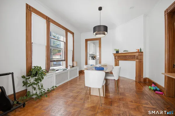 a view of a dining room with furniture window and wooden floor