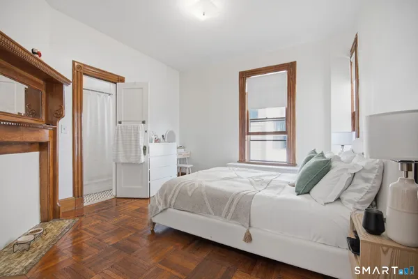 a bedroom with a bed and a window