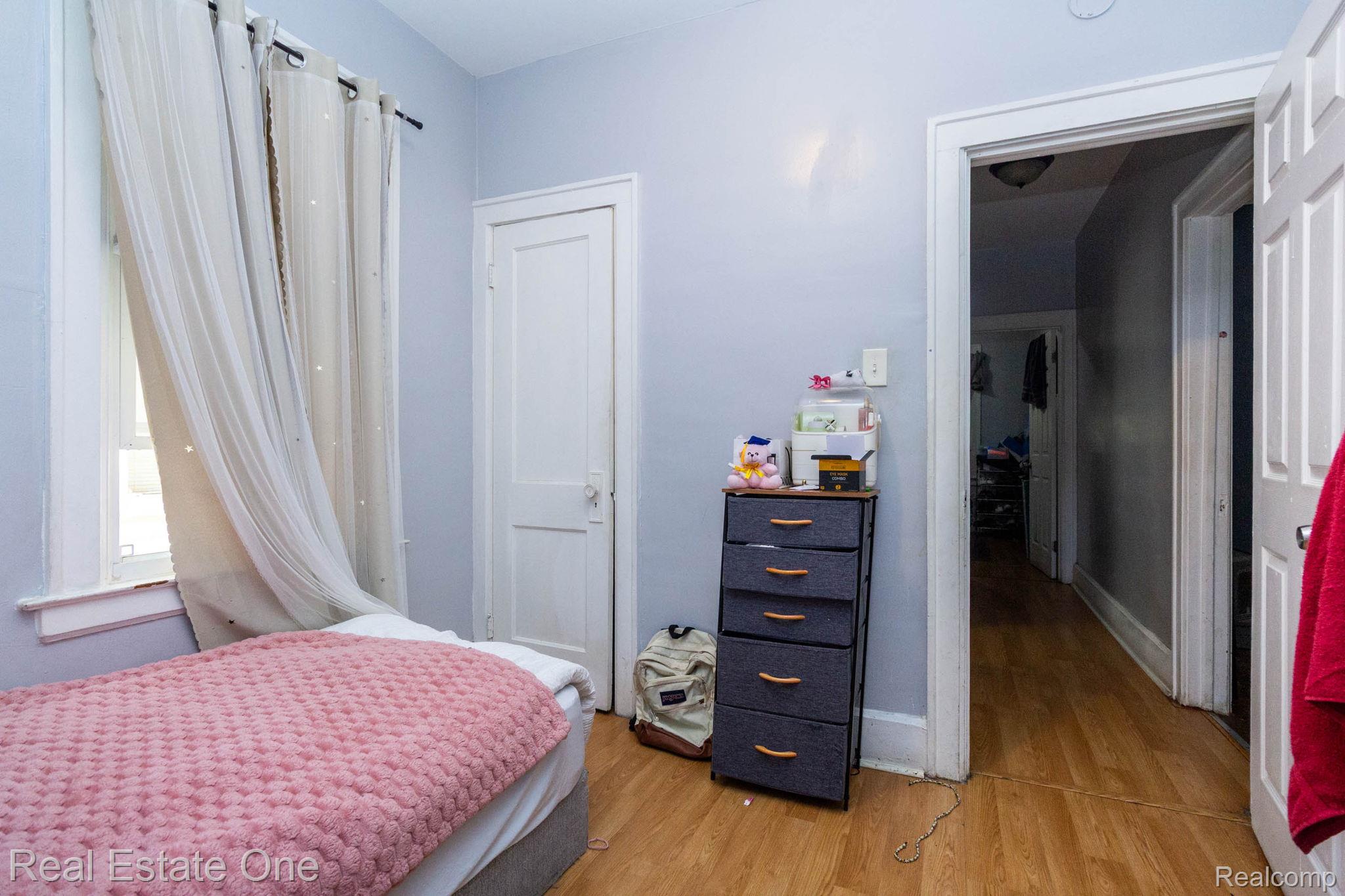 5485 Springwells Street Detroit, MI 48210 - Photo 15 of 47 Bedroom featuring light blue walls, wood-finish flooring, and a white window frame