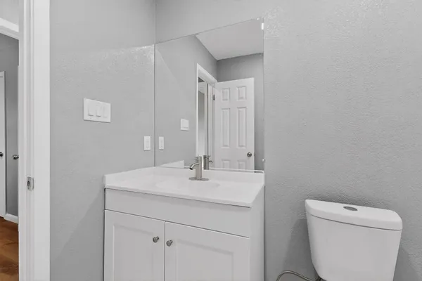 a bathroom with a toilet sink and mirror