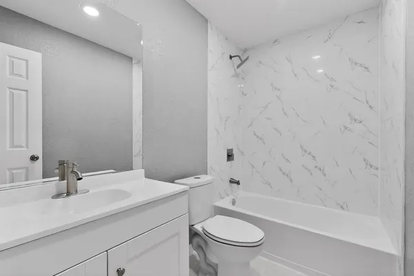 a bathroom with a sink a toilet and a bathtub