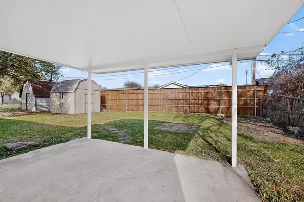 a view of a backyard with wooden fence
