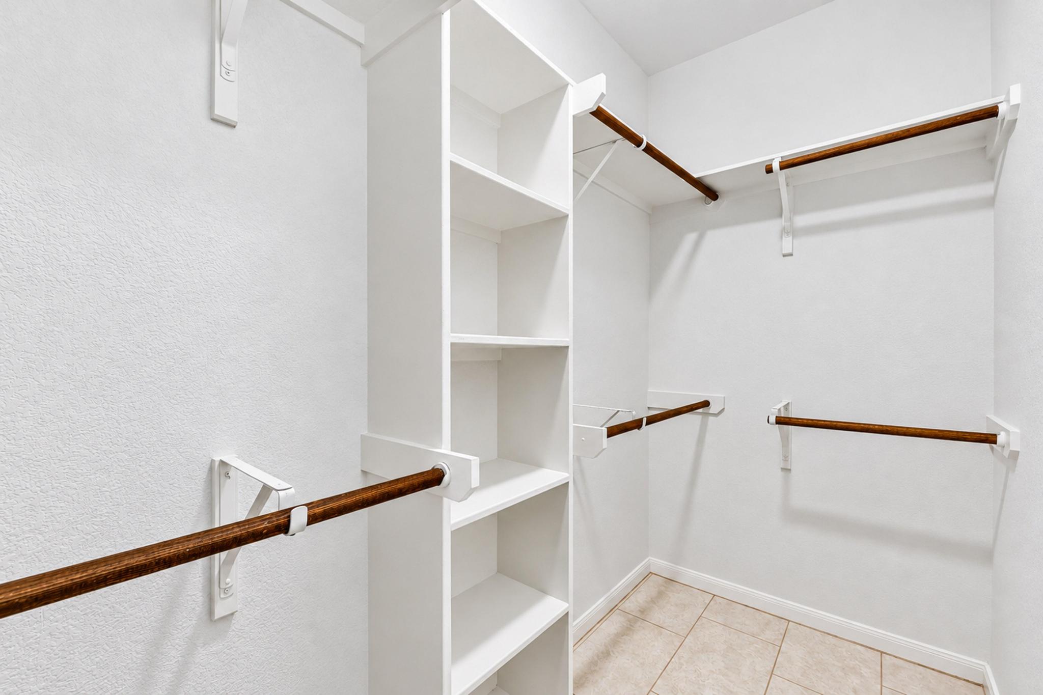 150 Engineers Pass Jarrell, TX 76537 - Photo 34 of 40 Ample built-in shelving and hanging rods maximize storage in this tiled closet.