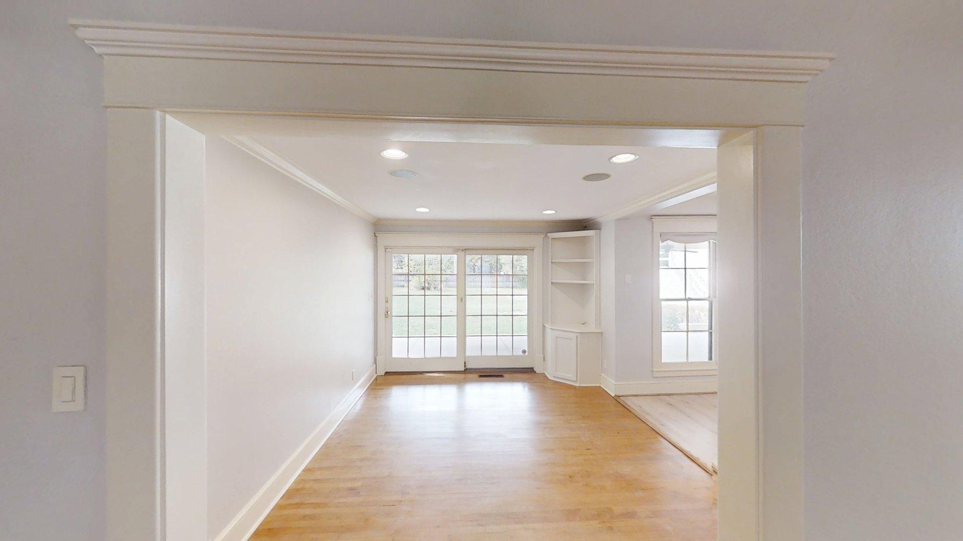 219 F Street Southwest Ardmore, OK 73401 - Photo 9 of 58 Wide doorway with detailed trim, recessed lighting, wood-finish flooring, and built-in shelving