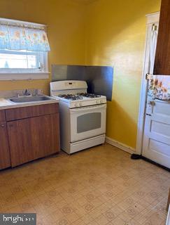 7837 Provident Street Philadelphia, PA 19150 - Photo 5 of 16 Sunny kitchen with cheerful yellow walls.