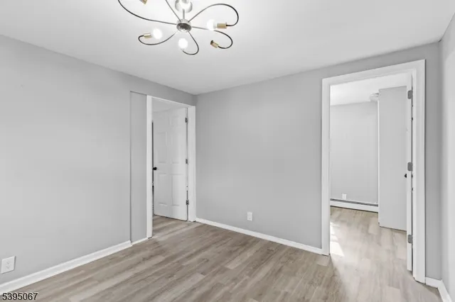 a view of a room with wooden floor