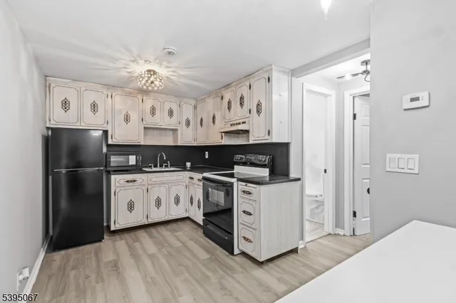 a kitchen with stainless steel appliances a refrigerator sink and cabinets