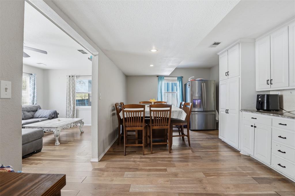 500 West Rucker Street Granbury, TX 76048 - Photo 13 of 35 a view of a dining room with furniture and wooden floor