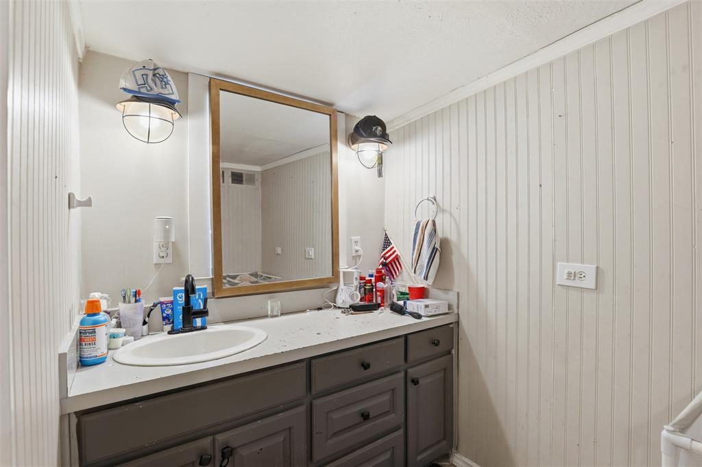 500 West Rucker Street Granbury, TX 76048 - Photo 17 of 35 a bathroom with a sink vanity and a mirror
