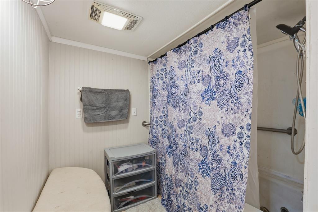 500 West Rucker Street Granbury, TX 76048 - Photo 18 of 35 a bathroom with a toilet and a shower curtain