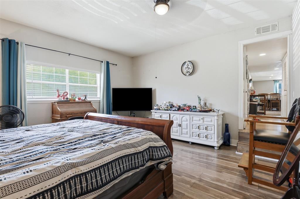 500 West Rucker Street Granbury, TX 76048 - Photo 21 of 35 a bedroom with a bed and a flat screen tv