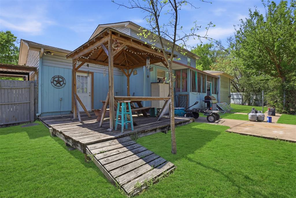 500 West Rucker Street Granbury, TX 76048 - Photo 27 of 35 a view of a chair and table in backyard of the house