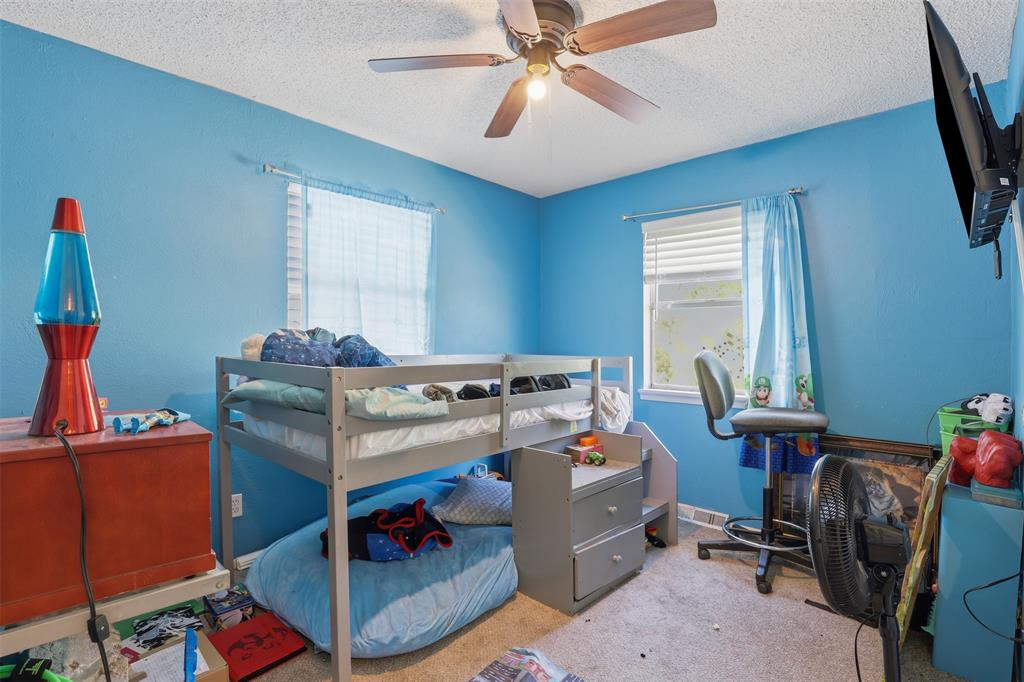 500 West Rucker Street Granbury, TX 76048 - Photo 33 of 35 a room with furniture a air conditioner and a window