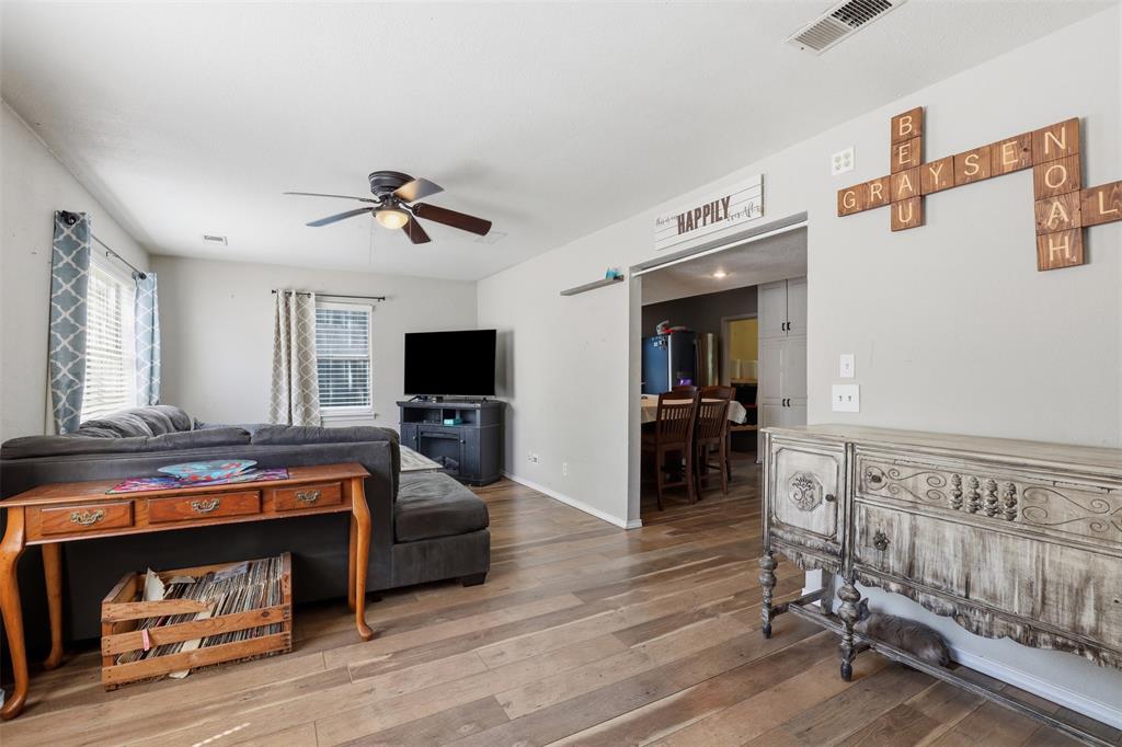 500 West Rucker Street Granbury, TX 76048 - Photo 6 of 35 a living room with furniture and a flat screen tv
