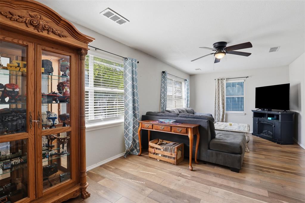 500 West Rucker Street Granbury, TX 76048 - Photo 7 of 35 a living room with furniture a flat screen tv and a fireplace