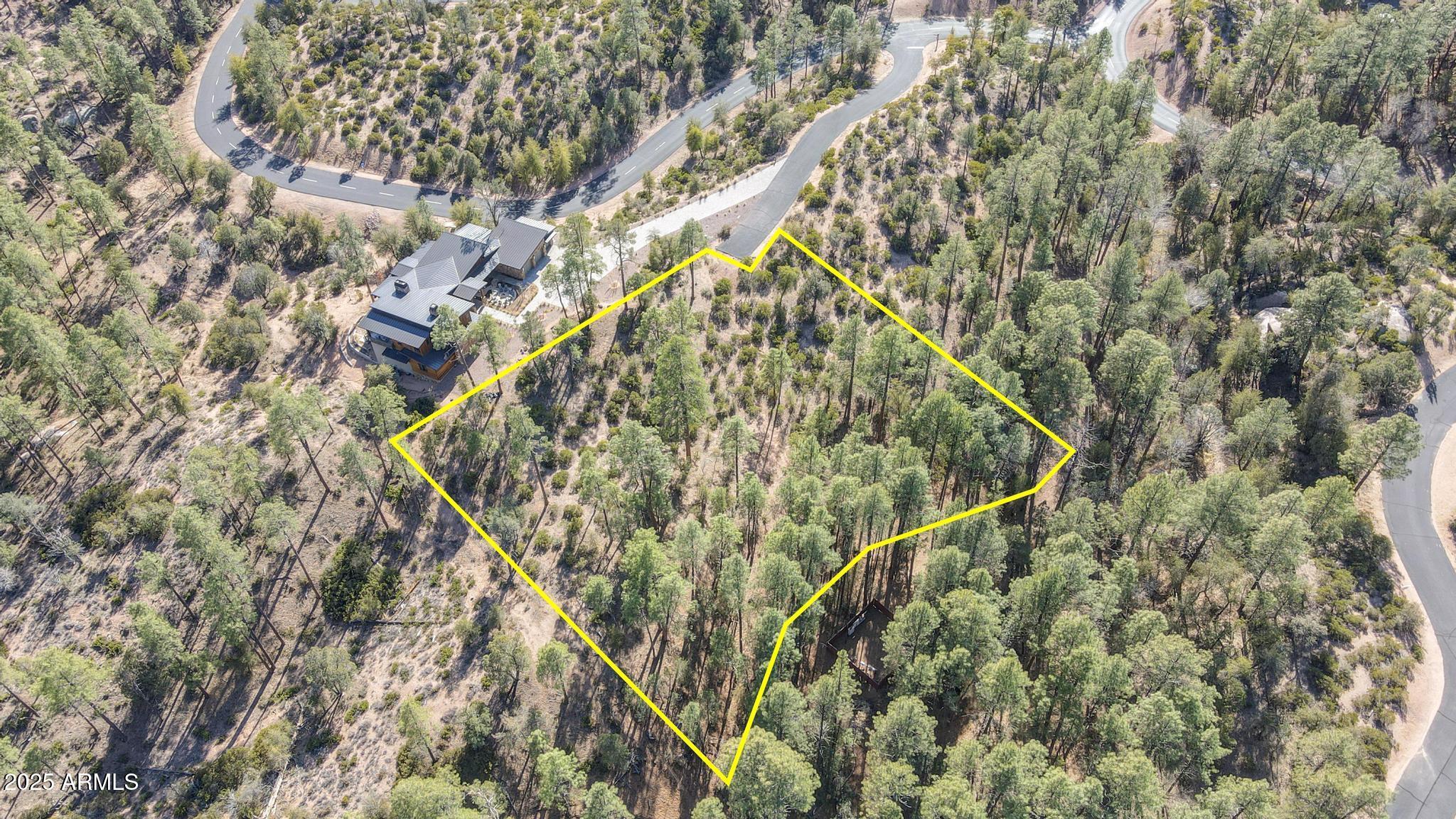 3103 South Monument Peak, Unit 168 Payson, AZ 85541 - Photo 13 of 13 a backyard of a house with a yard and wooden trees