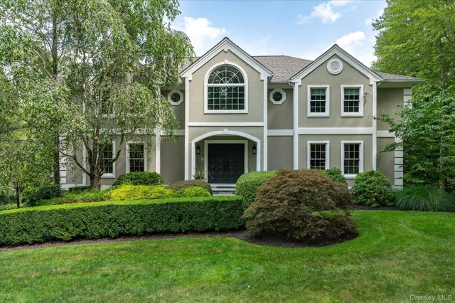 a front view of a house with a garden and yard