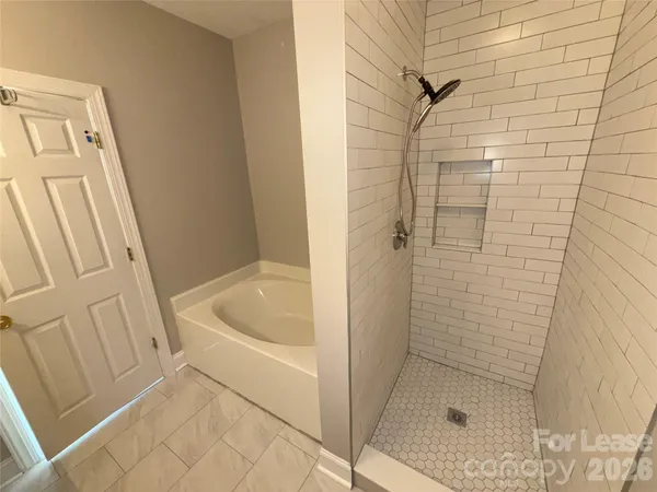 a bathroom with a tub and shower