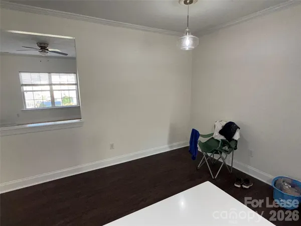 a picture of a room with a wooden floor and a window