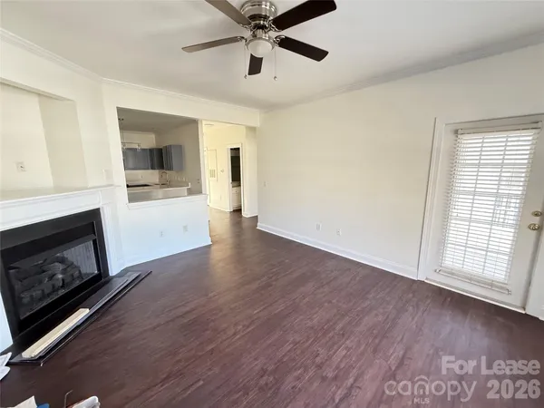 a view of an empty room with a fireplace and a window