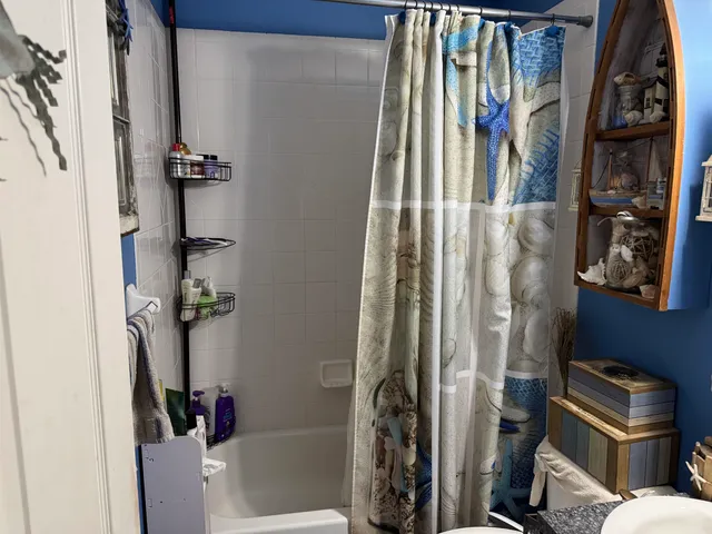 a bedroom with a bed and a mirror on the dresser