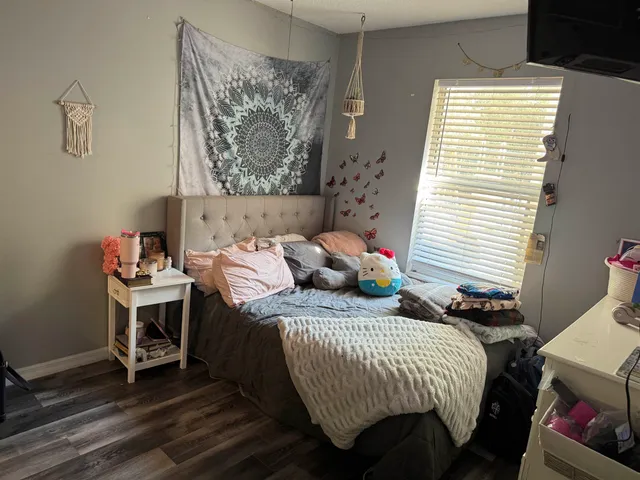 a room with wooden floor and gym equipment