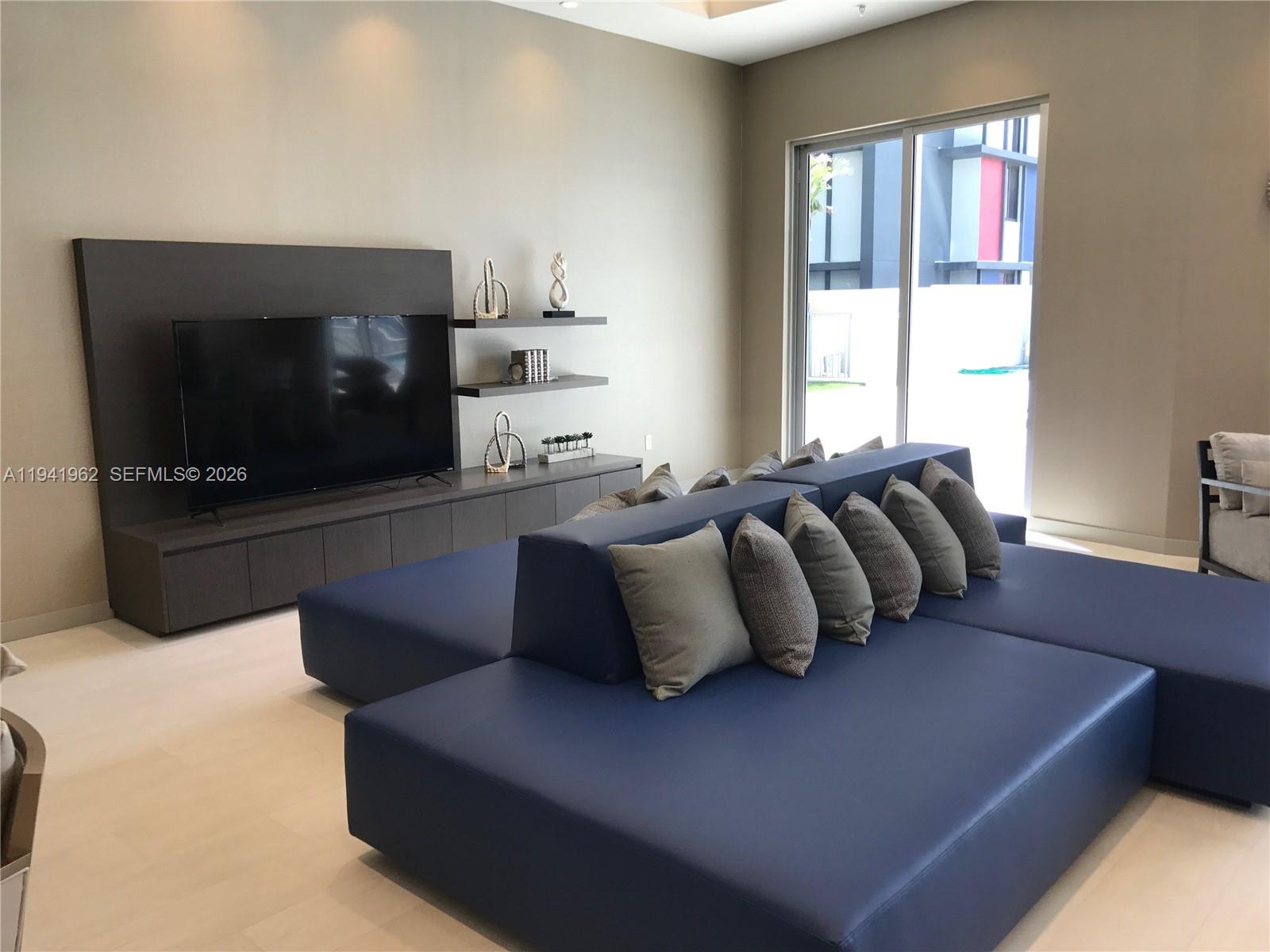 1010 Southwest 2nd Avenue, Unit 506 Miami, FL 33130 - Photo 18 of 76 a living room with furniture and a flat screen tv