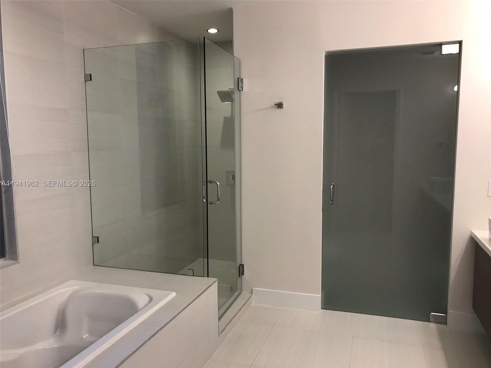 1010 Southwest 2nd Avenue, Unit 506 Miami, FL 33130 - Photo 63 of 76 a bathroom with a bathtub and a shower
