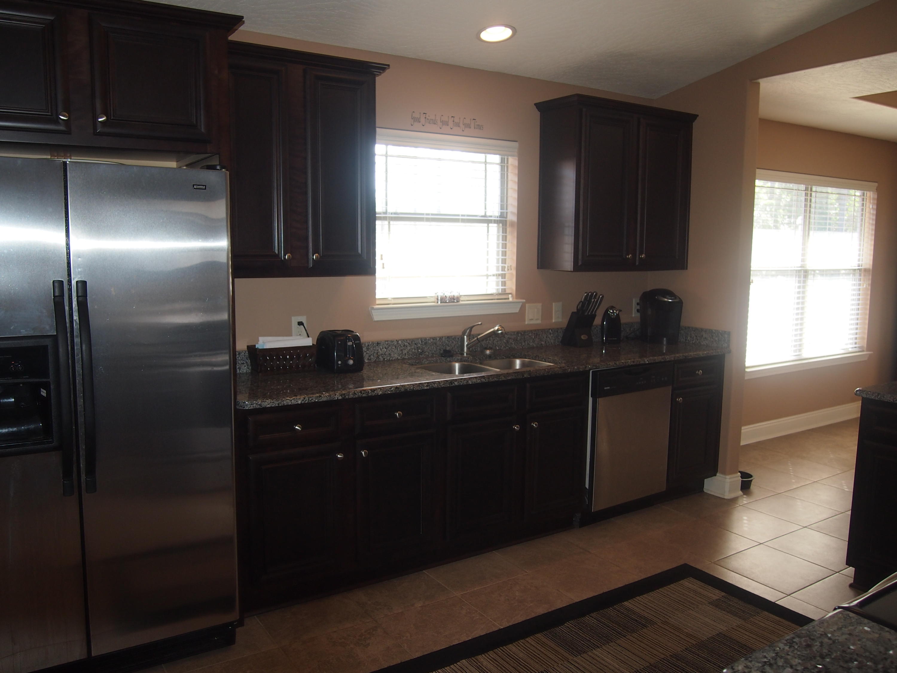 9273 Sundance Court Navarre, FL 32566 - Photo 12 of 33 a kitchen with a sink a window and cabinets