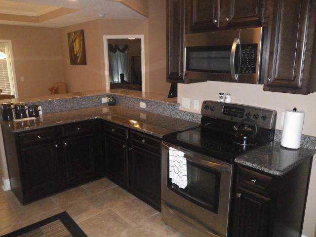 9273 Sundance Court Navarre, FL 32566 - Photo 14 of 33 a kitchen with a sink and a stove top oven