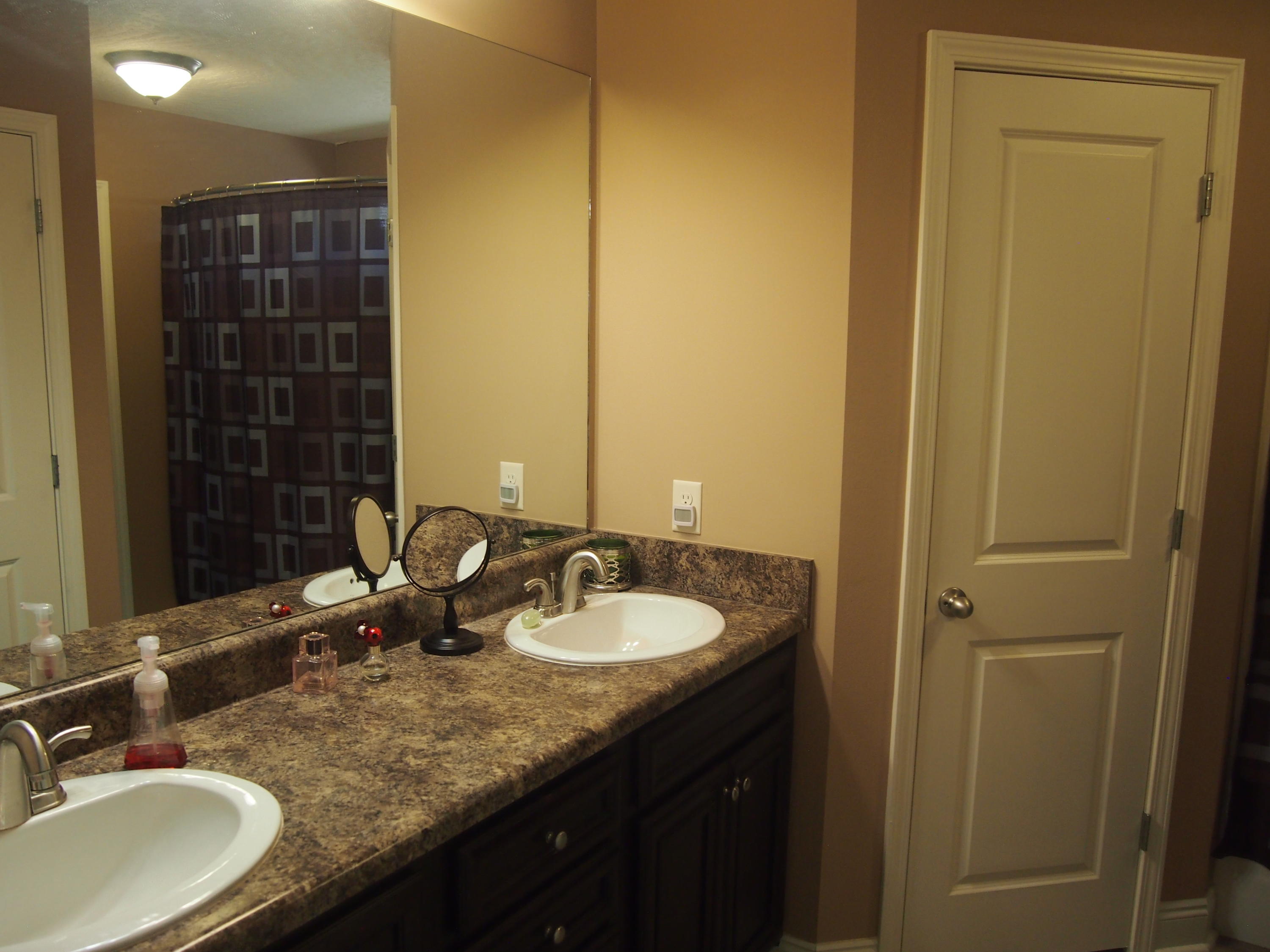 9273 Sundance Court Navarre, FL 32566 - Photo 18 of 33 a bathroom with a granite countertop sink and a mirror